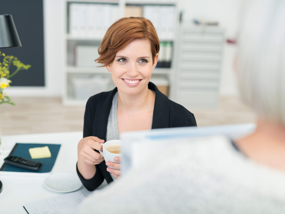 Office employee speaking with a colleague. 